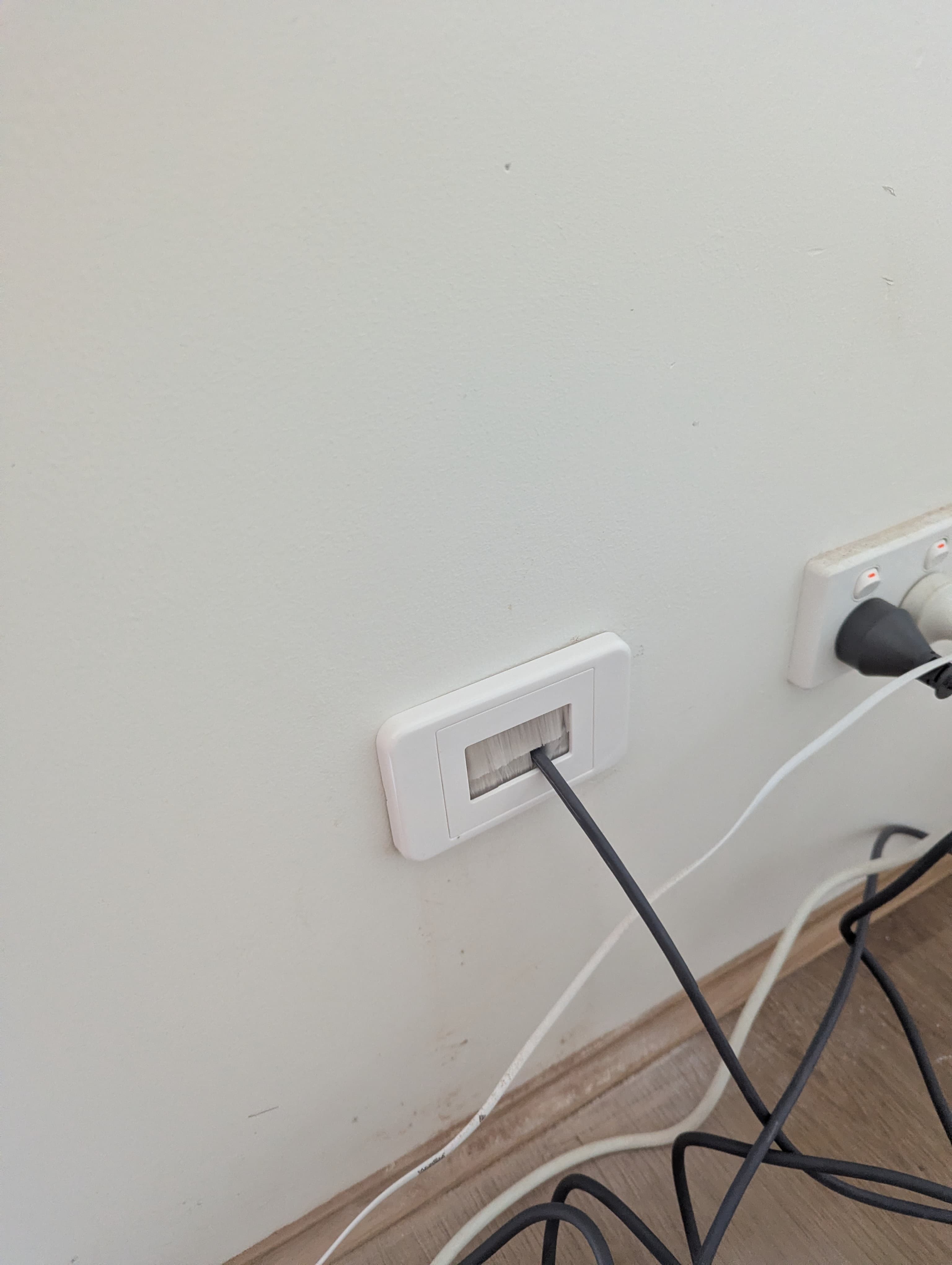 Starlink cable entering through a wall with a dust plate