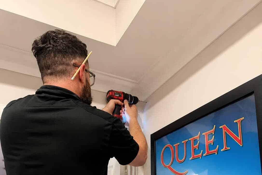 Daniel from Blake Smart Solutions drilling during an Ajax alarm installation