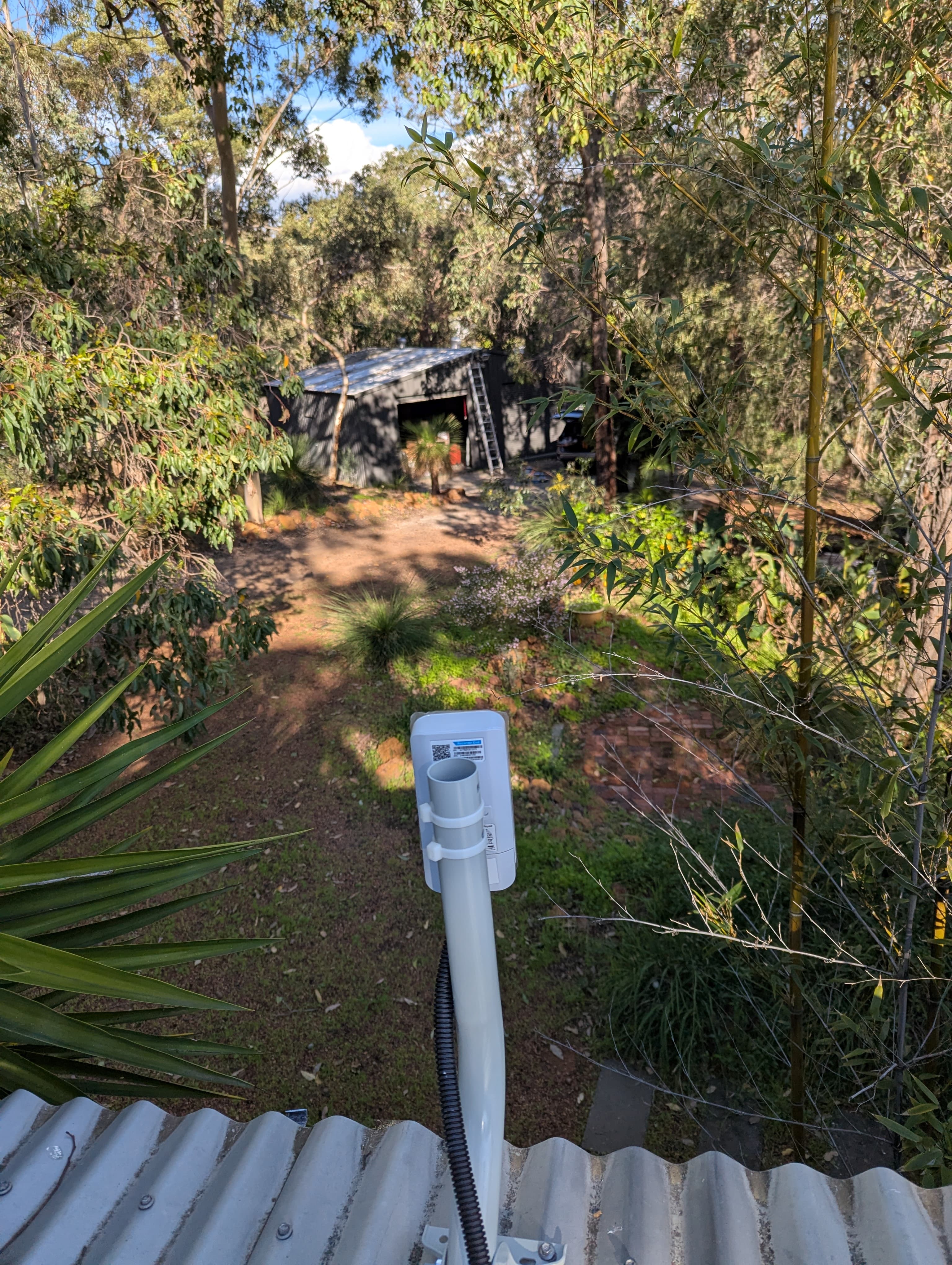 Wireless bridge installed on a roof to carry WiFi to a detached shed