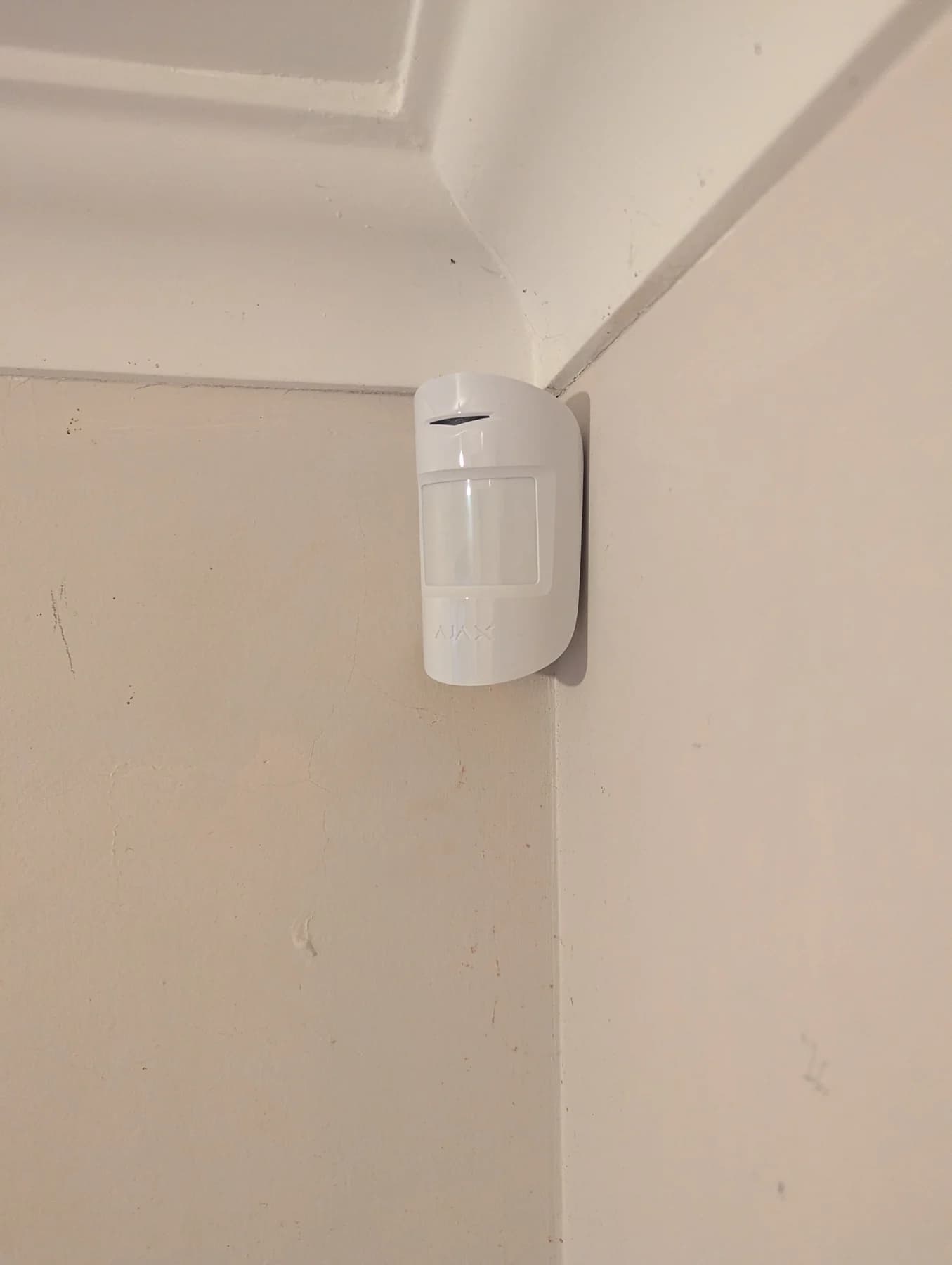 White Ajax MotionProtect sensor installed in the corner of a room in Innaloo
