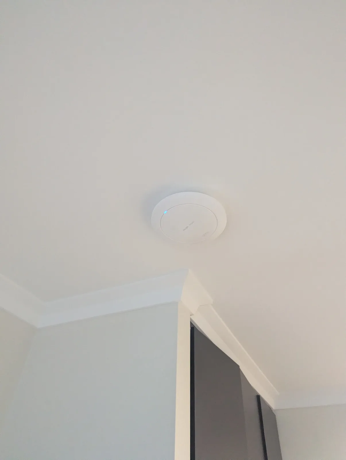 Hardwired ceiling-mounted Wi-Fi access point installed in a Hocking family home